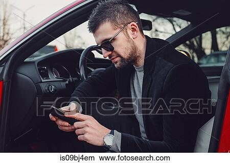 Bearded businessman using mobile phone in luxury car View Large Photo Image Picture - Bearded businessman using mobile phone in luxury car. Fotosearch