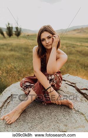 Beautiful young woman sitting cross legged on boulder, portrait, Exeter, California, USA View Large Photo Image Stock Image - Beautiful young woman sitting cross legged on boulder, portrait, Exeter, California, USA. Fotosearch