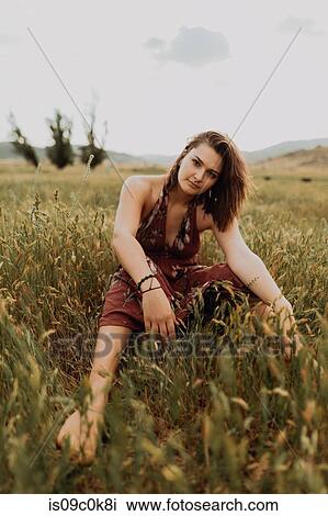 Beautiful young woman sitting in field of long grass, portrait, Exeter, California, USA View Large Photo Image Stock Image - Beautiful young woman sitting in field of long grass, portrait, Exeter, California, USA. Fotosearch