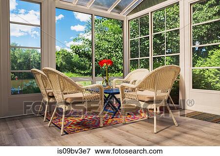 Beige wicker armchairs and blue wooden table in sunroom View Large Photo Image Stock Photo - Beige wicker armchairs and blue wooden table in sunroom. Fotosearch