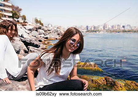 Best friends relaxing on rocks View Large Photo Image Stock Photo - Best friends relaxing on rocks. Fotosearch