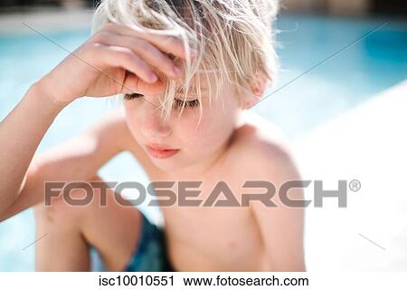 Blond haired boy in swimming shorts sitting at hotel poolside with eyes closed, selective focus, Las Vegas, Nevada, USA View Large Photo Image Stock Image - Blond haired boy in swimming shorts sitting at hotel poolside with eyes closed, selective focus, Las Vegas, Nevada, USA. Fotosearch