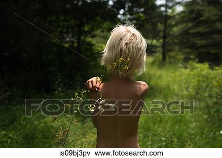 Blond haired boy in woodland holding wildflower on his shoulder, rear view View Large Photo Image Stock Photo - Blond haired boy in woodland holding wildflower on his shoulder, rear view. Fotosearch