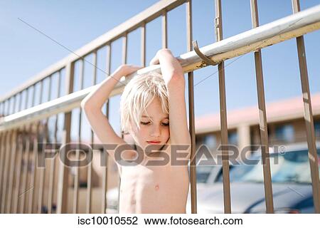 Blond haired boy with eyes closed holding handrail at hotel poolside, Las Vegas, Nevada, USA View Large Photo Image Stock Image - Blond haired boy with eyes closed holding handrail at hotel poolside, Las Vegas, Nevada, USA. Fotosearch