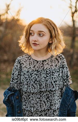 Stock Photograph - Blond haired young woman looking sideways, Menemsha, Martha's Vineyard, Massachusetts, USA. Fotosearch
