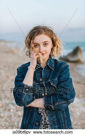 Stock Photo - Blond haired young woman on beach, portrait, Menemsha, Martha's Vineyard, Massachusetts, USA. Fotosearch