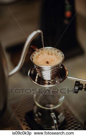 Boiled kettle water pouring into coffee filter on cafe counter, close up shallow focus View Large Photo Image Stock Photography - Boiled kettle water pouring into coffee filter on cafe counter, close up shallow focus. Fotosearch