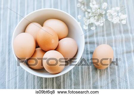 Stock Photo - Bowl of eggs on table cloth, overhead still life. Fotosearch