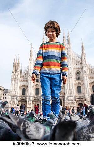 Boy amongst pigeons in Milan Cathedral square, Milan, Lombardy, Italy View Large Photo Image Stock Photo - Boy amongst pigeons in Milan Cathedral square, Milan, Lombardy, Italy. Fotosearch