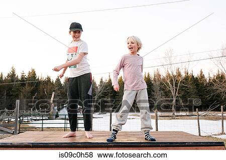 Boy and sister dancing on top of rural concrete slab View Large Photo Image Stock Photo - Boy and sister dancing on top of rural concrete slab. Fotosearch