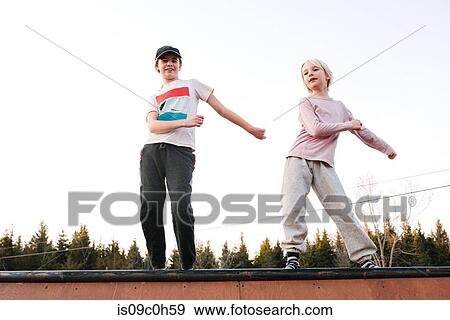 Boy and sister dancing on top of rural wooden structure View Large Photo Image Stock Photo - Boy and sister dancing on top of rural wooden structure. Fotosearch