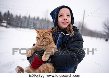 Boy carrying cat in snow View Large Photo Image Stock Image - Boy carrying cat in snow. Fotosearch