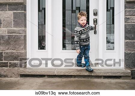 Boy closing door to leave house View Large Photo Image Stock Photography - Boy closing door to leave house. Fotosearch