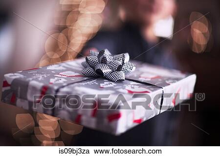 Boy handing over Christmas gift View Large Photo Image Stock Image - Boy handing over Christmas gift. Fotosearch