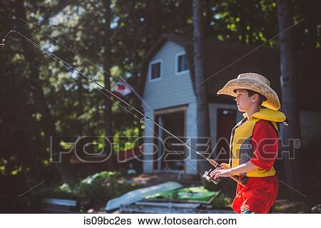 Boy in cowboy hat fishing from lakeside View Large Photo Image Stock Photograph - Boy in cowboy hat fishing from lakeside. Fotosearch
