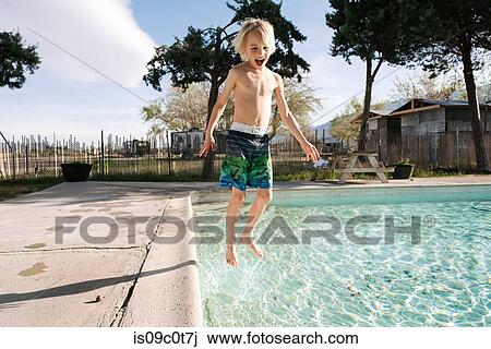Boy jumping into swimming pool, Olancha, California, US View Large Photo Image Stock Image - Boy jumping into swimming pool, Olancha, California, US. Fotosearch