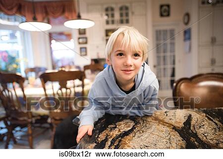 Boy leaning forward on sofa View Large Photo Image Stock Photography - Boy leaning forward on sofa. Fotosearch
