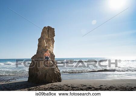 Boy on rock, El Matador Beach, Malibu, USA View Large Photo Image Stock Photo - Boy on rock, El Matador Beach, Malibu, USA. Fotosearch