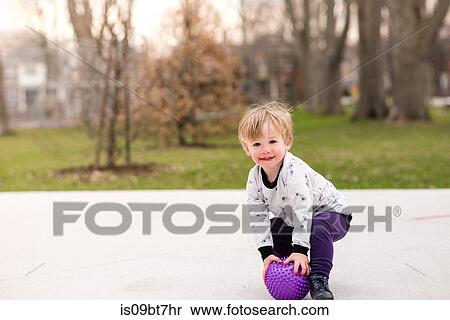 Boy playing ball in park View Large Photo Image Stock Photography - Boy playing ball in park. Fotosearch