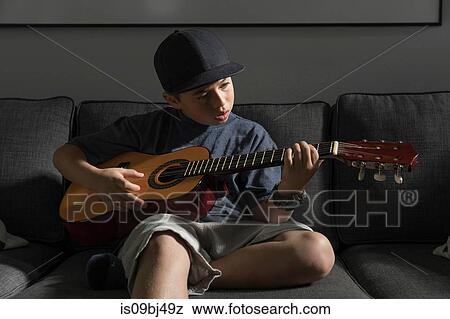 Boy playing guitar View Large Photo Image Stock Photo - Boy playing guitar. Fotosearch