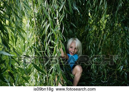 Boy playing under willow tree View Large Photo Image Stock Image - Boy playing under willow tree. Fotosearch