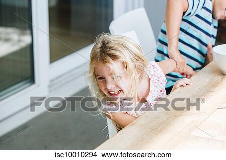 Boy pulling sister's hand playfully at dining table View Large Photo Image Picture - Boy pulling sister's hand playfully at dining table. Fotosearch