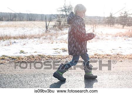 Stock Photograph - Boy reading clue note in countryside. Fotosearch