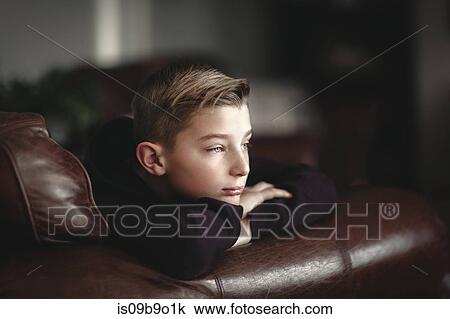 Boy relaxing on leather sofa View Large Photo Image Stock Image - Boy relaxing on leather sofa. Fotosearch