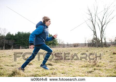 Boy running in field View Large Photo Image Stock Photo - Boy running in field. Fotosearch