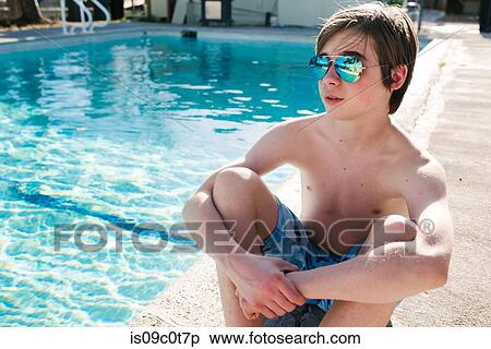 Boy sitting by swimming pool View Large Photo Image Stock Photography - Boy sitting by swimming pool. Fotosearch