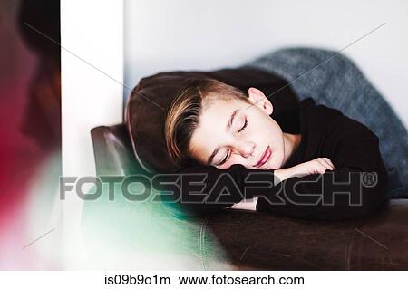 Boy sleeping on leather sofa View Large Photo Image Picture - Boy sleeping on leather sofa. Fotosearch