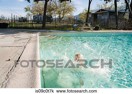 Boy splashing in swimming pool, Olancha, California, US View Large Photo Image Stock Image - Boy splashing in swimming pool, Olancha, California, US. Fotosearch