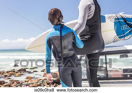 Boy surfer and father preparing on back of truck on beach, cropped view, Cape Town, Western Cape, South Africa View Large Photo Image Stock Photo - Boy surfer and father preparing on back of truck on beach, cropped view, Cape Town, Western Cape, South Africa. Fotosearch
