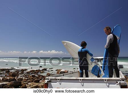 Boy surfer and father preparing surfboards on back of truck on beach, Cape Town, Western Cape, South Africa View Large Photo Image Stock Image - Boy surfer and father preparing surfboards on back of truck on beach, Cape Town, Western Cape, South Africa. Fotosearch