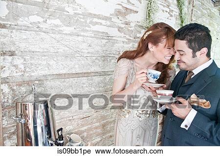 Bride and groom, drinking tea from tea cups, laughing View Large Photo Image Stock Image - Bride and groom, drinking tea from tea cups, laughing. Fotosearch