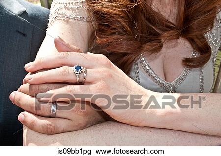 Bride and groom, holding hands, close-up, mid section View Large Photo Image Stock Image - Bride and groom, holding hands, close-up, mid section. Fotosearch