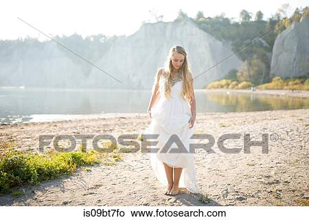 Bride in wedding dress on beach at sunset, Scarborough Bluffs, Toronto, Canada View Large Photo Image Picture - Bride in wedding dress on beach at sunset, Scarborough Bluffs, Toronto, Canada. Fotosearch