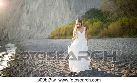 Bride in wedding dress on beach at sunset, Scarborough Bluffs, Toronto, Canada View Large Photo Image Stock Photo - Bride in wedding dress on beach at sunset, Scarborough Bluffs, Toronto, Canada. Fotosearch