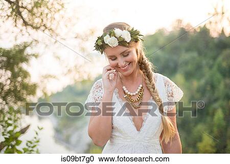 Stock Image - Bride on clifftop by coast, Scarborough Bluffs, Toronto, Canada. Fotosearch