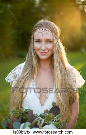 Bride with bouquet at sunset View Large Photo Image Stock Photo - Bride with bouquet at sunset. Fotosearch