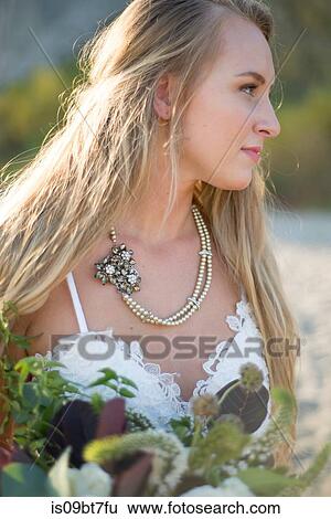 Bride with bouquet on beach View Large Photo Image Stock Photograph - Bride with bouquet on beach. Fotosearch