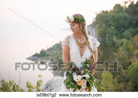 Bride with bouquet on clifftop by coast, Scarborough Bluffs, Toronto, Canada View Large Photo Image Stock Image - Bride with bouquet on clifftop by coast, Scarborough Bluffs, Toronto, Canada. Fotosearch