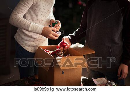 Brother and sister putting up Christmas decorations View Large Photo Image Stock Image - Brother and sister putting up Christmas decorations. Fotosearch