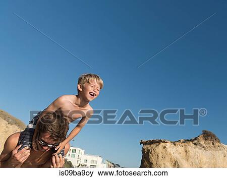 Stock Photo - Brothers playing on El Matador Beach, Malibu, USA. Fotosearch