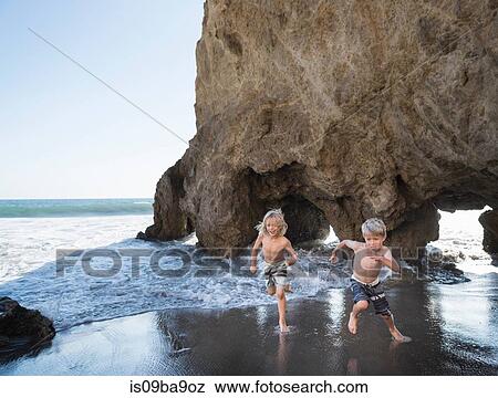 Brothers playing on El Matador Beach, Malibu, USA View Large Photo Image Stock Photo - Brothers playing on El Matador Beach, Malibu, USA. Fotosearch