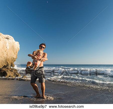 Brothers playing on El Matador Beach, Malibu, USA View Large Photo Image Stock Photo - Brothers playing on El Matador Beach, Malibu, USA. Fotosearch