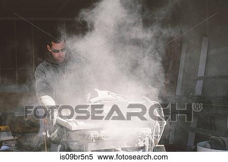 Builder cutting tiles View Large Photo Image Stock Photography - Builder cutting tiles. Fotosearch
