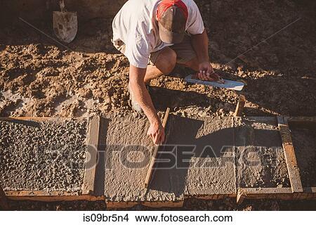 Builder laying cement foundation View Large Photo Image Picture - Builder laying cement foundation. Fotosearch