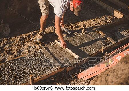 Builder laying cement foundation View Large Photo Image Stock Image - Builder laying cement foundation. Fotosearch