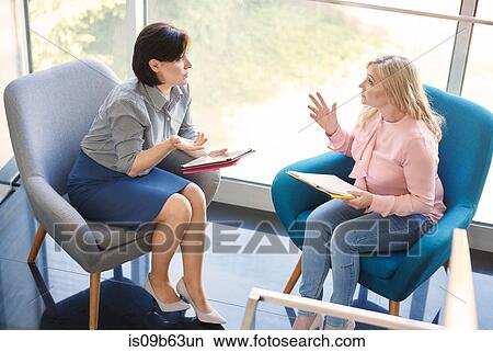 Business women having discussion in meeting View Large Photo Image Picture - Business women having discussion in meeting. Fotosearch